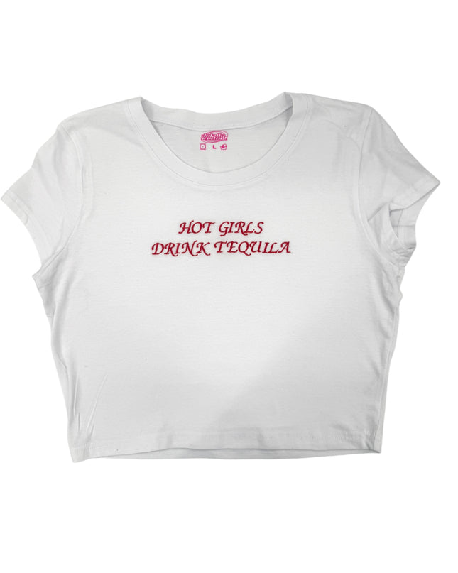 A white crop top with the text "HOT GIRLS DRINK TEQUILA" printed on it in red lettering.