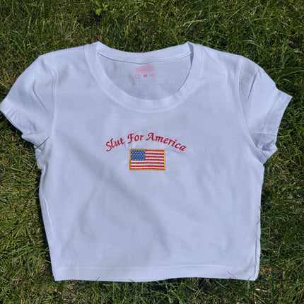 a white t - shirt with a flag on it