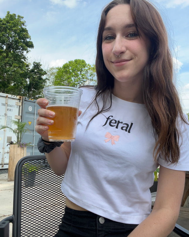 a woman holding a glass of beer in her hand