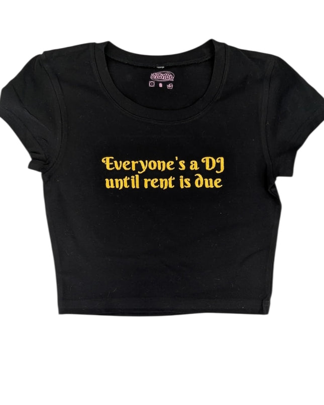A black crop top with yellow text printed on it.