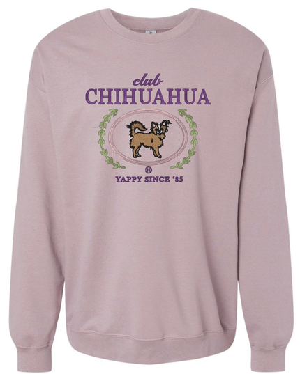 A pink sweatshirt with a graphic design featuring a chihuahua and the text "club CHIHUAHUA" and "YAPPY SINCE '85".