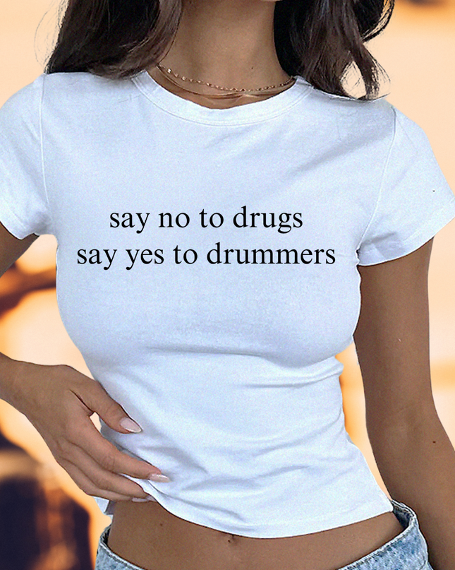 a woman wearing a white shirt that says say no to drugs say yes to drummer