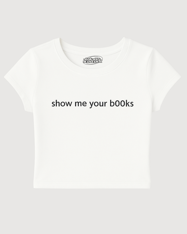 A white t-shirt with the text "show me your books" printed on it.