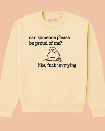 A yellow sweatshirt with a black cat graphic and text printed on it.