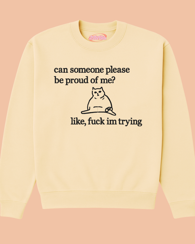 A yellow sweatshirt with a black cat graphic and text printed on it.