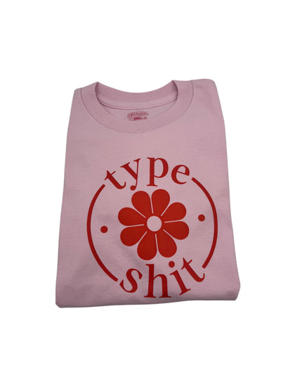 a pink shirt with a flower on it