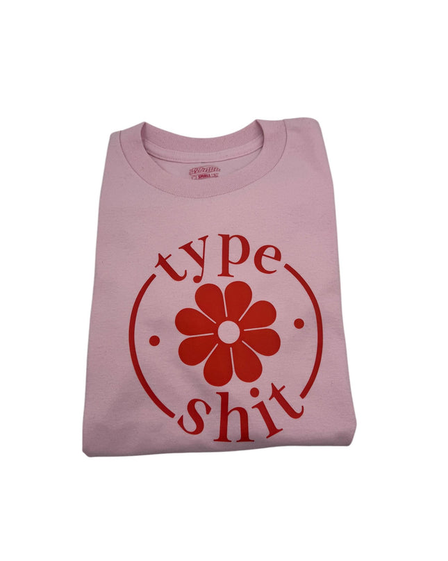a pink shirt with a flower on it