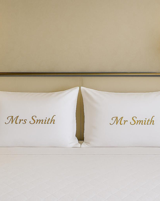 two pillows on top of a bed in a hotel room