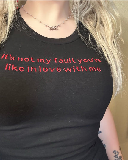 a woman wearing a black shirt with red writing on it