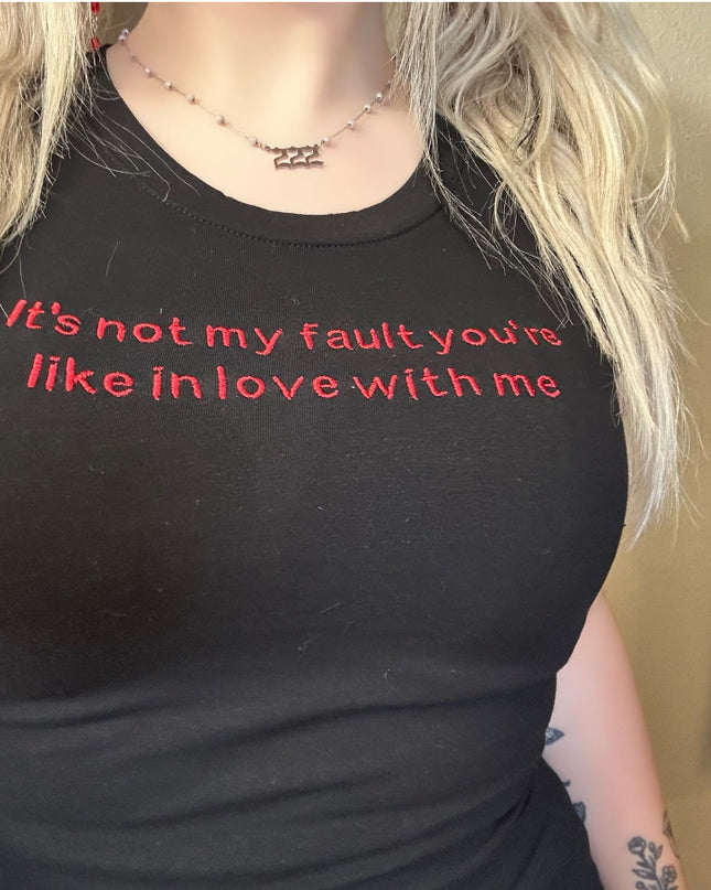 a woman wearing a black shirt with red writing on it
