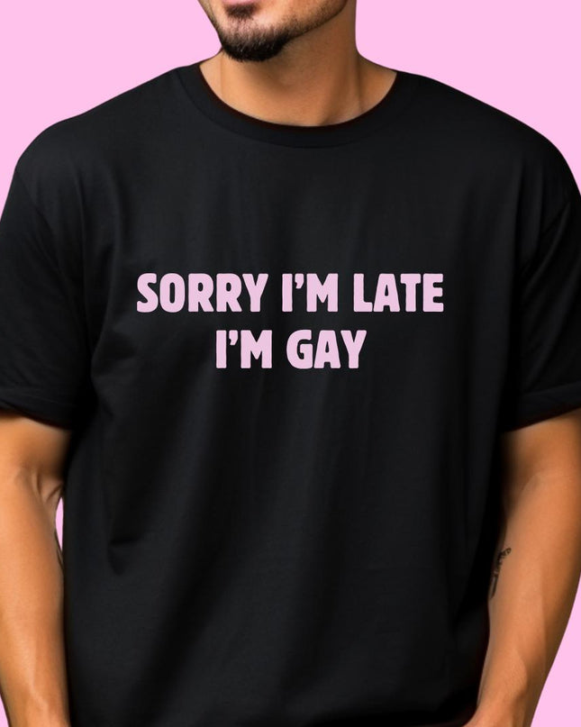 a man wearing a black shirt that says sorry i'm late i'm