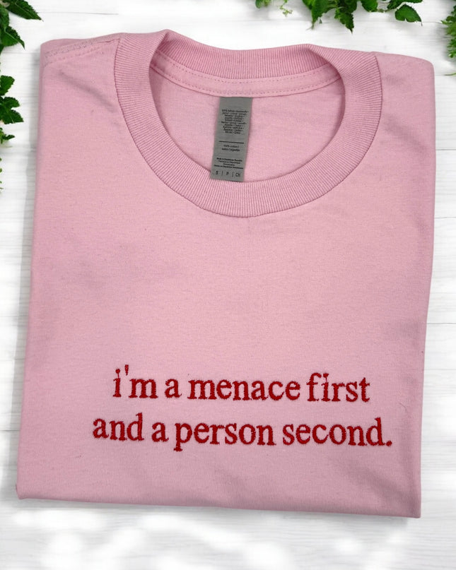 a pink shirt that says i'm a menace first and a person second