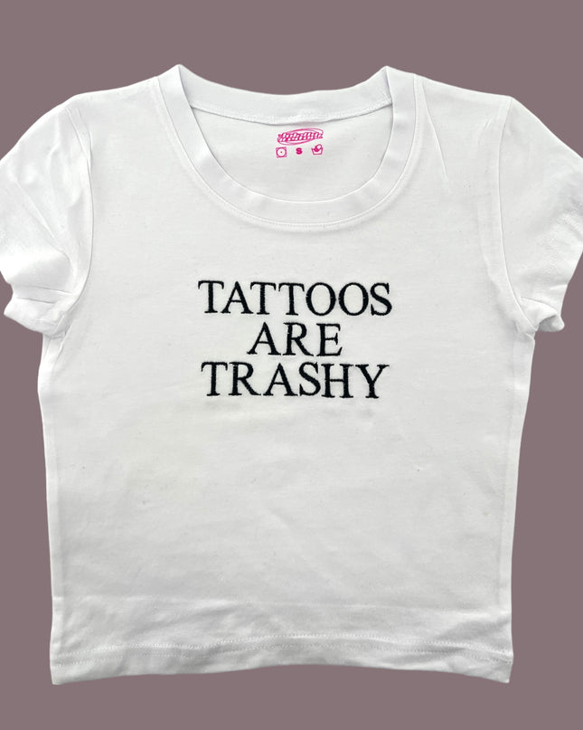 a white t - shirt that says tattoos are trashy