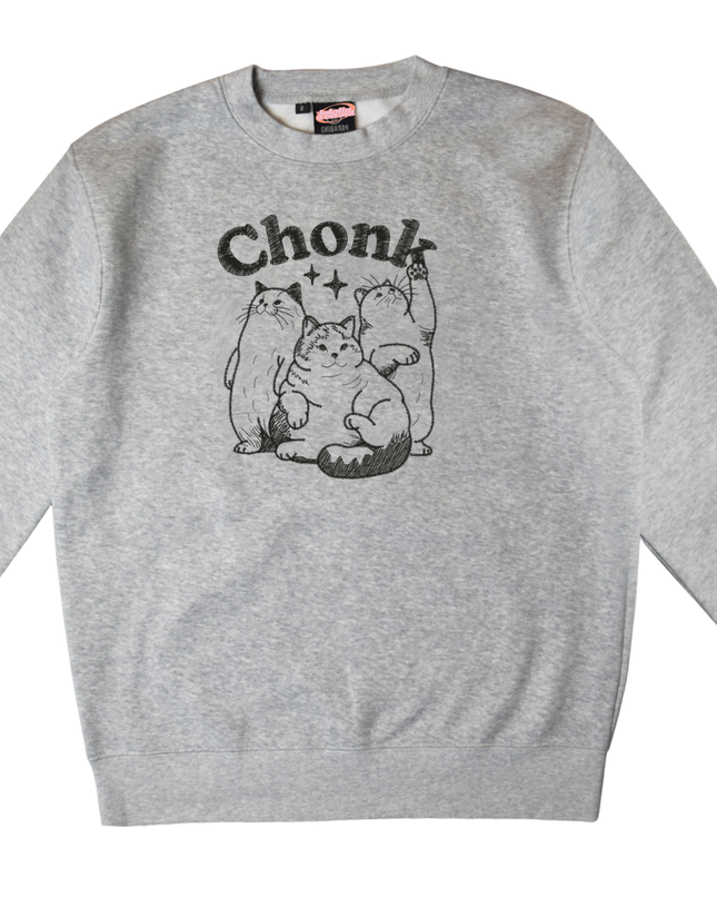 A gray sweatshirt with a black and white graphic design depicting three cats, along with the text "Chunk" above them.
