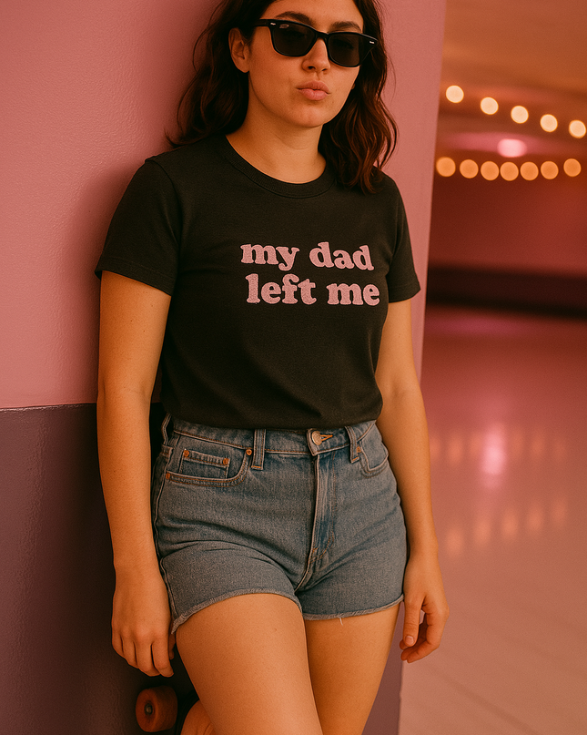 a woman leaning against a wall wearing a t - shirt that says, my dad