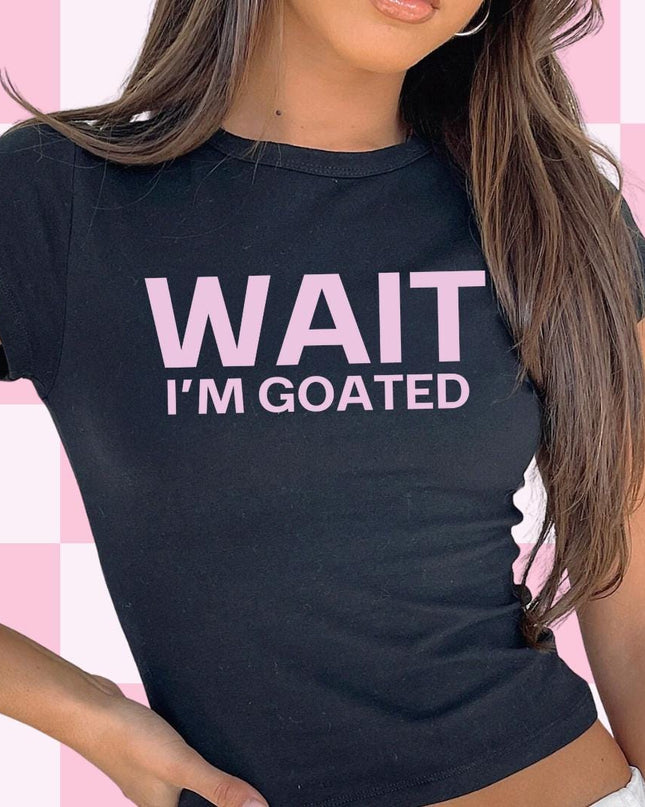 a woman wearing a t - shirt that says wait i'm goated