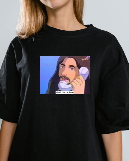 A black t-shirt with a graphic design depicting a man with long hair and a mustache talking on a phone, with the text "start the rapture" below the image.