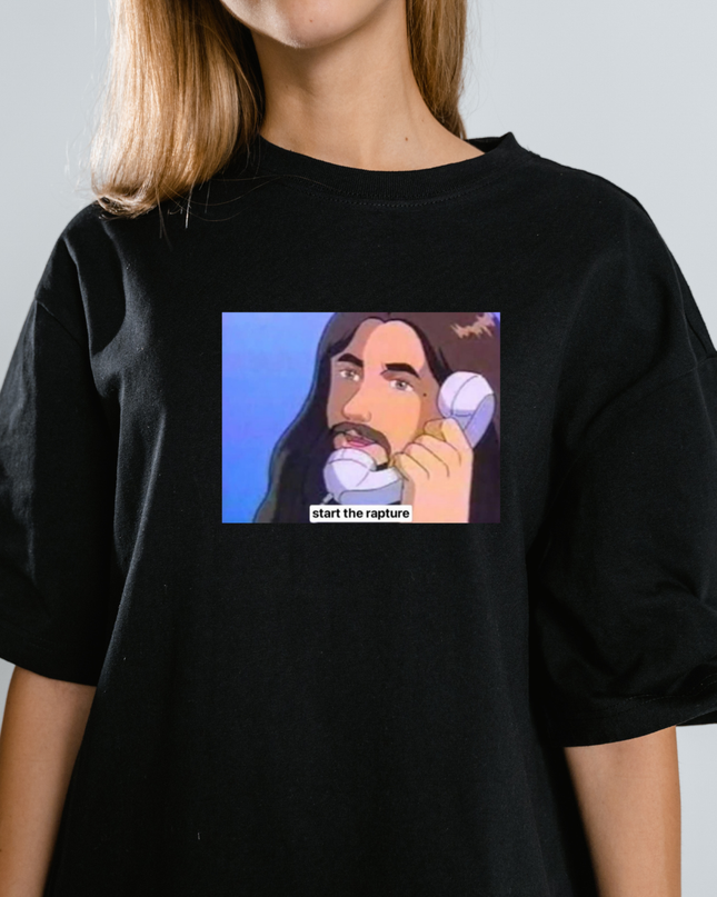 A black t-shirt with a graphic design depicting a man with long hair and a mustache talking on a phone, with the text "start the rapture" below the image.