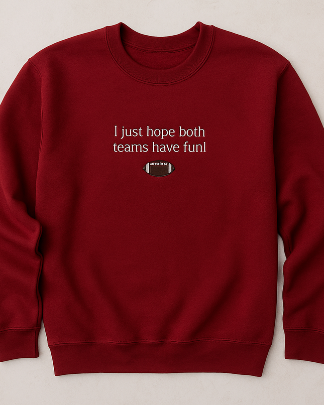 A red sweatshirt with the text "I just hope both teams have fun" printed on it.