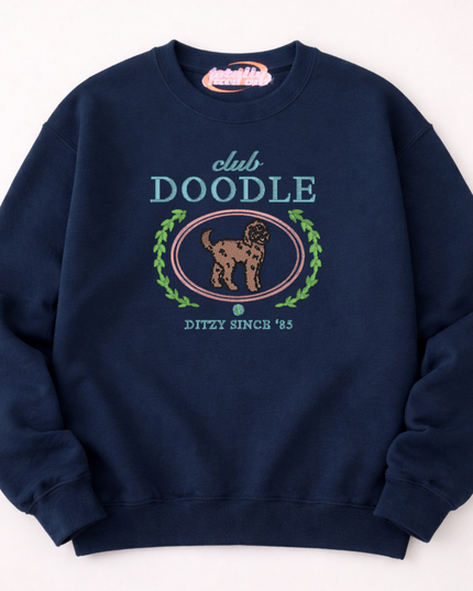 A navy blue sweatshirt with a graphic design featuring a dog and the text "club DOOLE" and "DITZY SINCE '85".