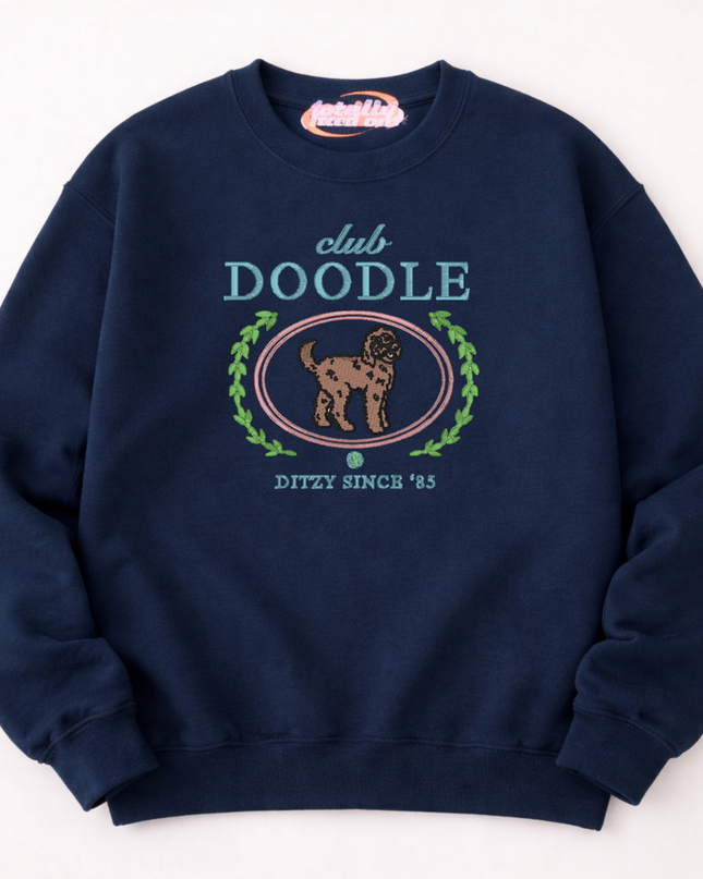 A navy blue sweatshirt with a graphic design featuring a dog and the text "club DOOLE" and "DITZY SINCE '85".