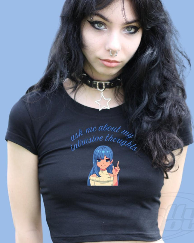 a woman wearing a black shirt with a picture of a girl on it