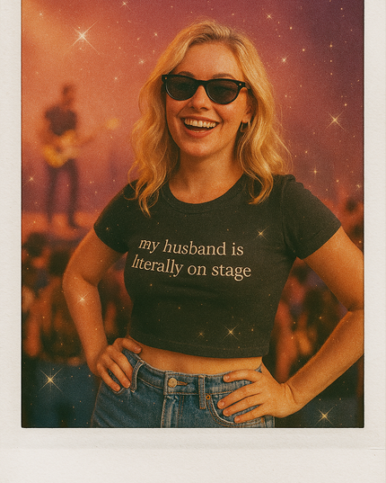 a woman wearing a t - shirt that says my husband is literally on stage