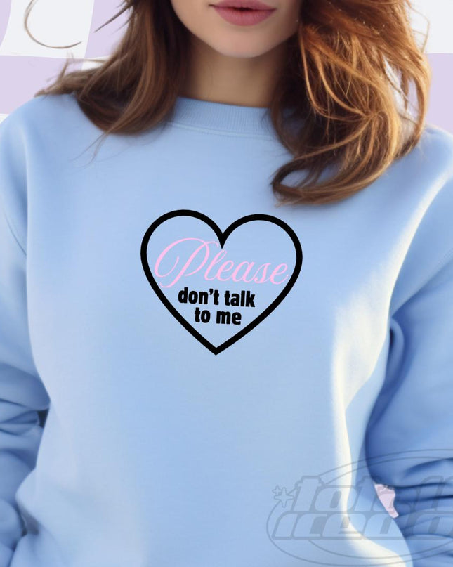 a woman wearing a blue sweatshirt with a heart on it