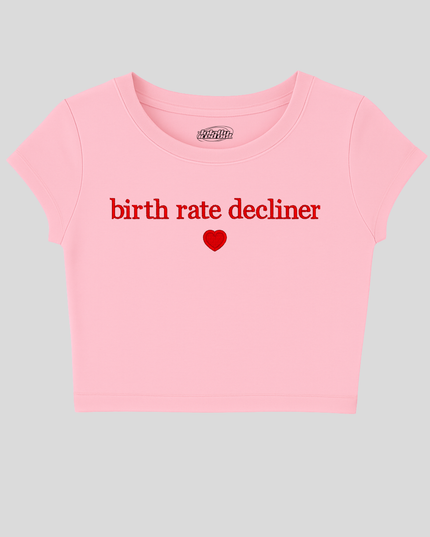 A pink cropped t-shirt with the text "birth rate decliner" printed on it.