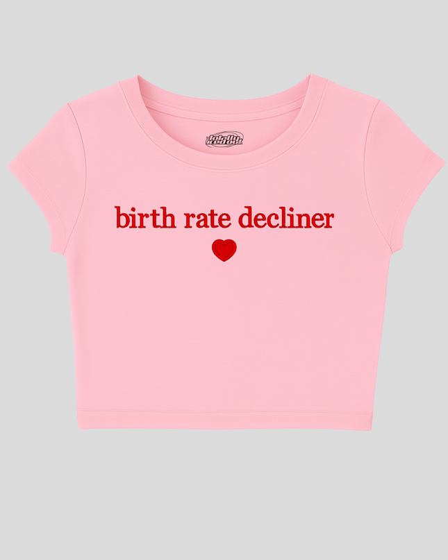 A pink cropped t-shirt with the text "birth rate decliner" printed on it.