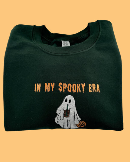 a green shirt with a ghost holding a drink