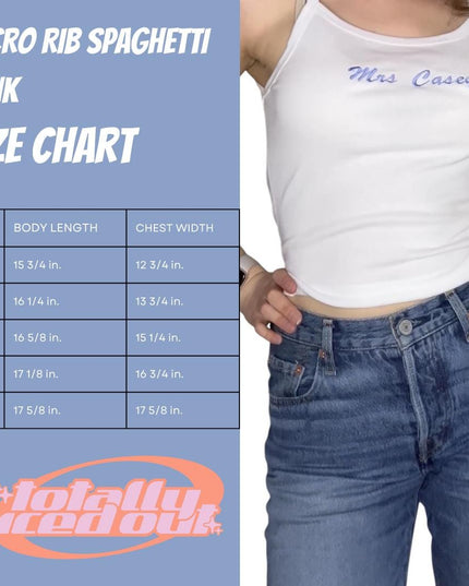 a woman wearing a white tank top and jeans