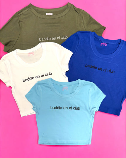 a group of three t - shirts sitting on top of a pink surface