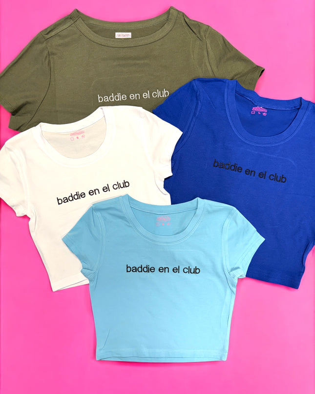 a group of three t - shirts sitting on top of a pink surface