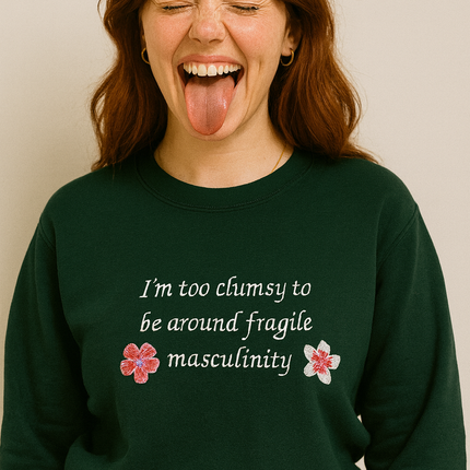 A woman with long brown hair wearing a green sweatshirt with text on it.