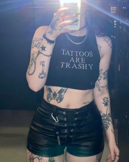 a woman with tattoos is taking a selfie