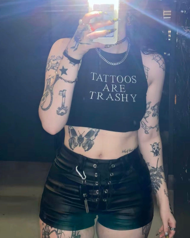 a woman with tattoos is taking a selfie