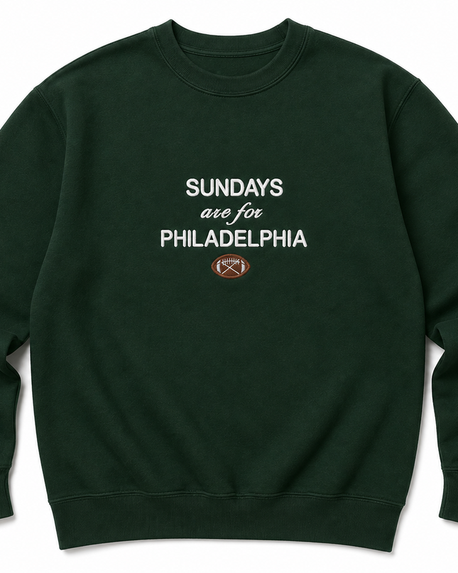 A dark green sweatshirt with white text that reads "SUNDAYS are for PHILADELPHIA" and an image of a football.