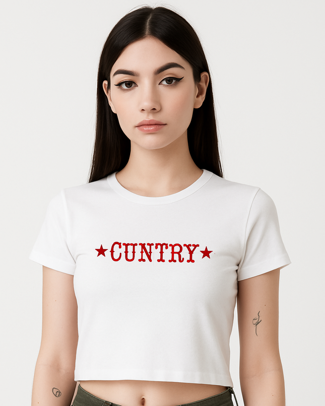 A young woman with long dark hair wearing a white crop top with the word "CUNTRY" printed on it.