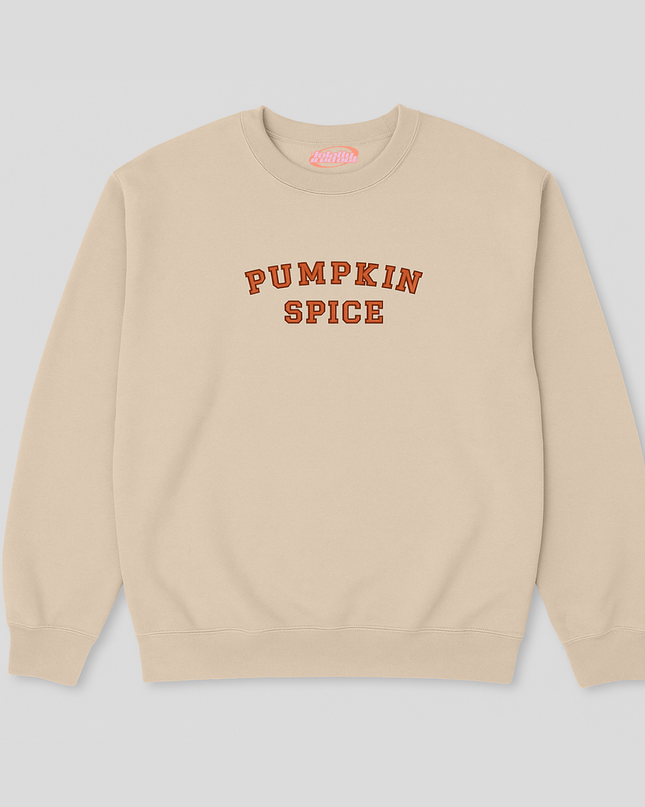 A beige sweatshirt with the text "PUMPKIN SPICE" printed on it in orange letters.