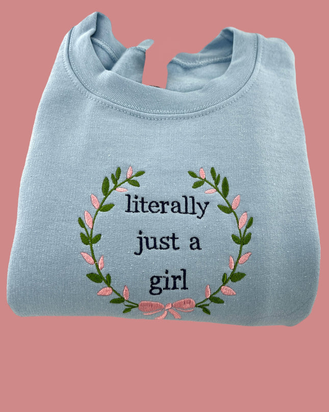 a blue sweatshirt with a floral wreath on it