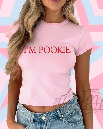 a woman wearing a pink shirt that says i'm pokie