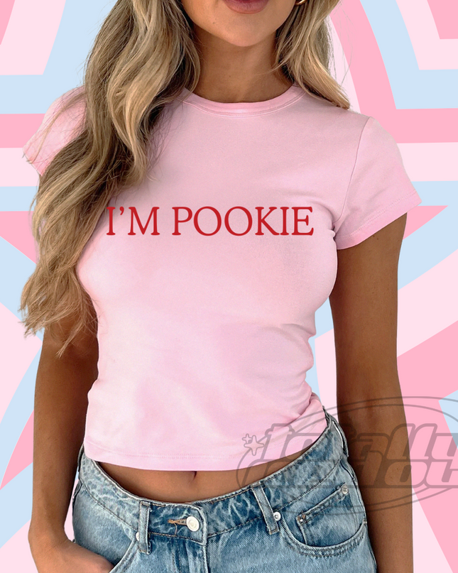a woman wearing a pink shirt that says i'm pokie