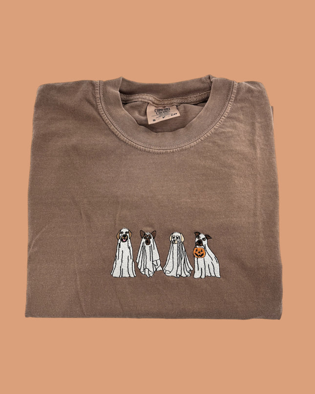 a brown t - shirt with three dogs on it