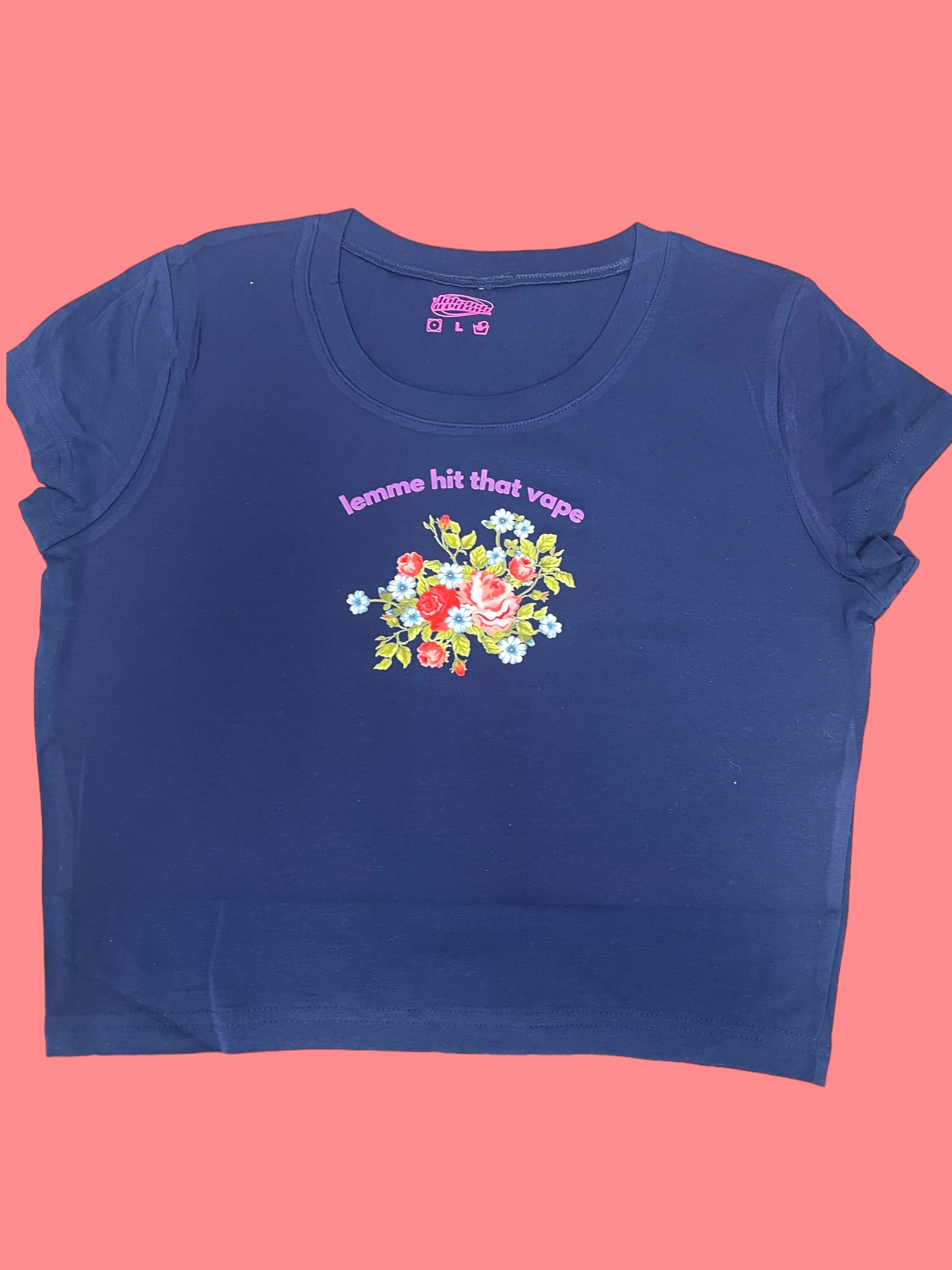 A navy blue t-shirt with a floral design and the text "lemme hit that vapor" printed on it.
