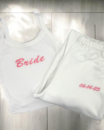 a white tank top with a pink bride embroidered on it