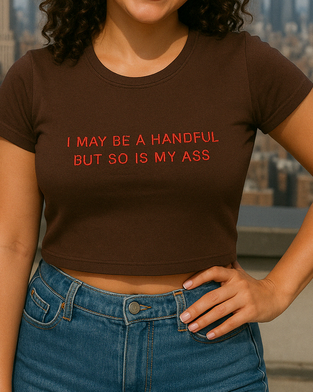 a woman wearing a brown shirt with a message on it