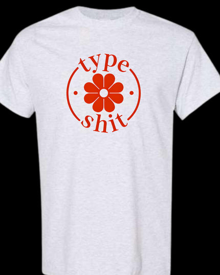 a white t - shirt with a red flower on the front