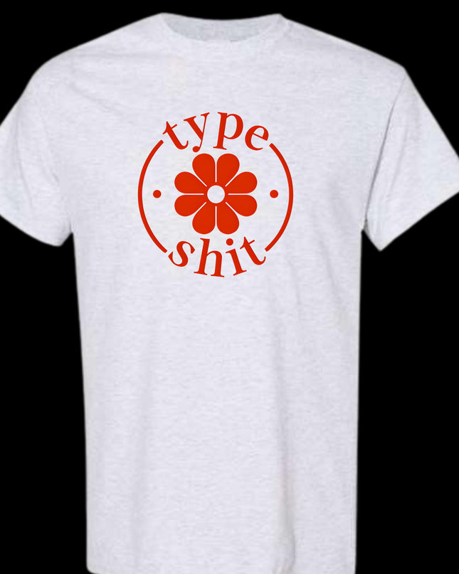 a white t - shirt with a red flower on the front
