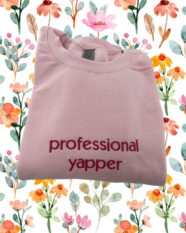 a pink t - shirt with the words professional yapper printed on it